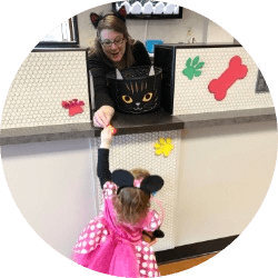 Young girl making a deposit dressed in a Halloween costume