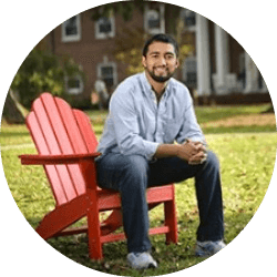 Man sitting in red chair outside