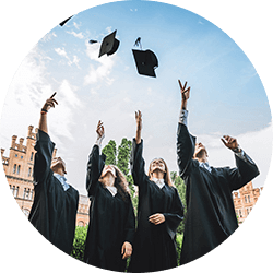 Graduates throwing their caps into the air