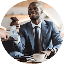 Man in suit paying for coffee with POS system