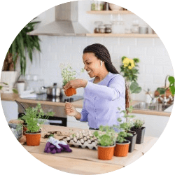 Woman working on starting plants for garden in her kitchen