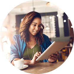 Woman using tablet in coffee shop