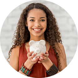 Teenage girl holding a piggy bank